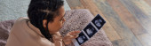 top view of african american woman lying on bed, looking at ultrasound, abortion concept, banner Poster #668923848