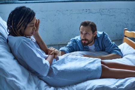 miscarriage concept, sad man calming down depressed african american wife, hospital, private ward
