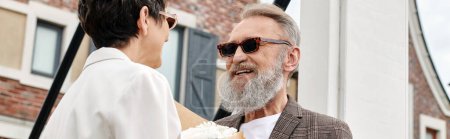 Photo for Banner, low angle view, elderly couple in sunglasses, positive man looking at woman, summer - Royalty Free Image