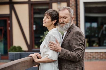 bearded man hugging woman, husband and wife, senior romance, love, aging population, outdoors