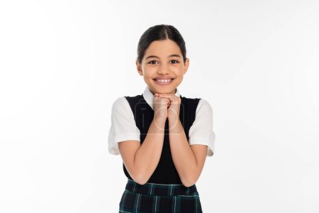 cheerful schoolgirl in black vest looking at camera isolated on white, school uniform, excitement