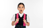 new school year, shocked girl with backpack looking at camera isolated on white, student in uniform t-shirt #670361222
