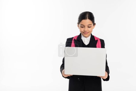 colegiala sonriente usando portátil aislado en blanco, e-estudio, estudiante en uniforme aislado en blanco