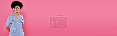 Photo for Breast cancer awareness, african american female doctor, oncologist with stethoscope, pink, banner - Royalty Free Image