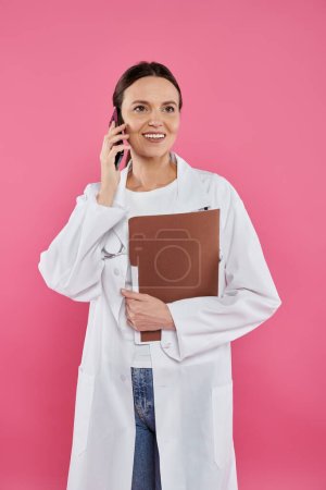 Photo for Breast cancer awareness, female doctor, happy oncologist talking on smartphone, online consultation - Royalty Free Image