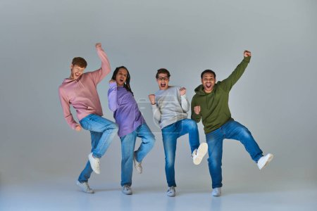 Photo for Multicultural happy friends in urban outfits jumping and having great time, cultural diversity - Royalty Free Image