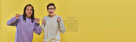 Photo for Cheerful multicultural friends in casual attire smiling with fists up, cultural diverse, banner - Royalty Free Image