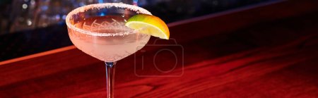 elegant glass of margarita garnished with lime with bar backdrop, concept, banner