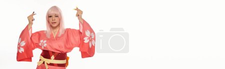 anime woman in pink  kimono sticking out tongue and showing mini hearts gesture on white, banner