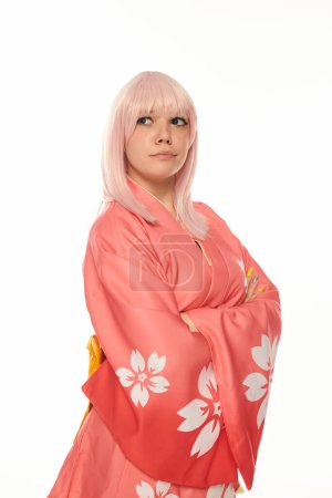 thoughtful blonde woman in pink kimono with folded arms looking away on white cosplay fashion