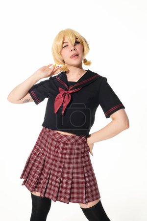 seductive anime style woman in yellow blonde wig and school uniform posing with hand on hip on white