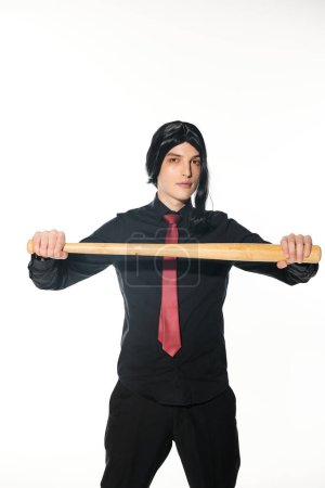 cosplay subculture, student in black clothes with wig and red tie holding baseball bat on white