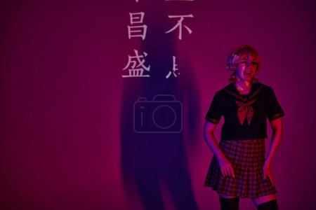 anime woman in school uniform sticking out tongue in neon light on purple backdrop with hieroglyphs