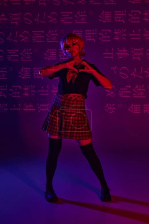 stylish anime woman in school uniform showing heart sign on neon purple backdrop with hieroglyphs