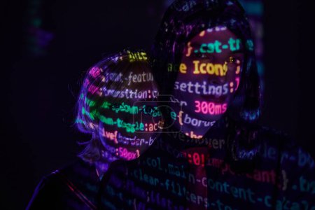 portrait of futuristic couple with neon programming lettering on dark backdrop, cosplay concept