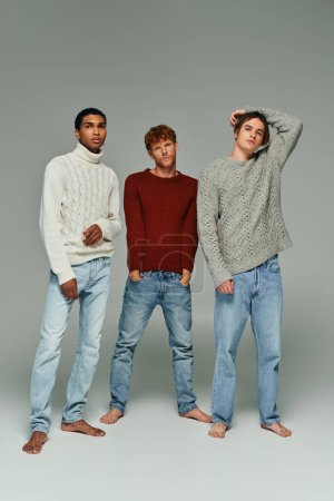 vertical shot of multicultural stylish men wearing warm cozy sweaters and looking at camera