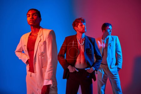 appealing diverse male models in elegant suits posing with neon lights on their faces, men power