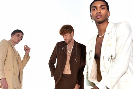good looking elegant diverse men in formalwear with accessories on white backdrop, fashion concept