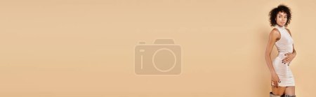 Photo for Charming african american woman posing in mini dress on beige backdrop, autumn fashion banner - Royalty Free Image