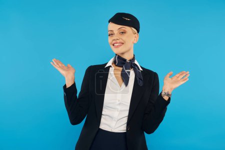 welcoming stewardess with open arms posing in elegant uniform on blue, professional hospitality