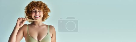 happy redhead and curvy woman with toothbrush smiling with closed eyes on beige, horizontal banner