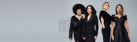 Photo for Glamorous multicultural girlfriends in total black outfits on grey backdrop, horizontal banner - Royalty Free Image