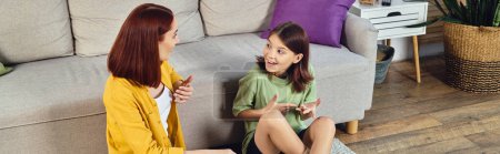excited teenage girl gesturing and talking with mother about sex at home, sex education banner
