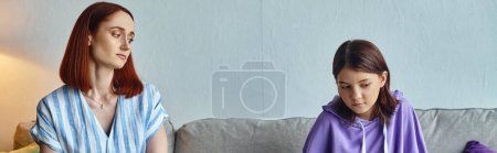 Photo for Caring mother looking at frustrated teenage daughter sitting on couch in living room, banner - Royalty Free Image