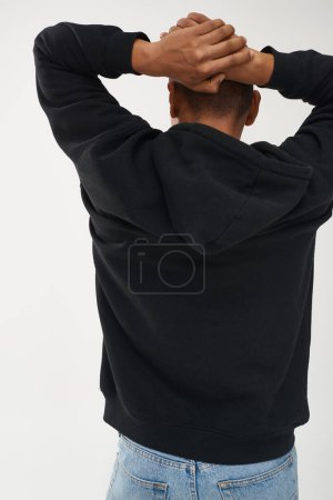 trendy african american male model in casual black hoodie and jeans, copy space for advertising