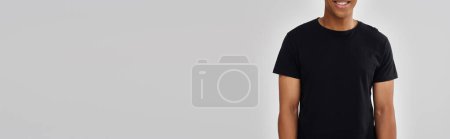 young stylish african american man in casual black t-shirt, copy space for advertising, banner