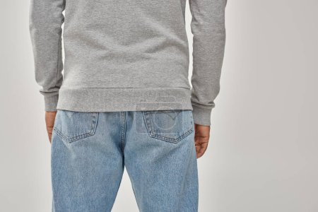 stylish african american man in gray casual sweatshirt and jeans, copy space for advertising