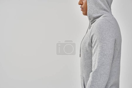 elegant african american man in casual sweatshirt on white background, copy space for advertising