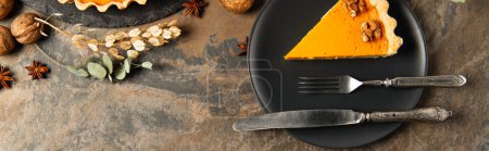 thanksgiving, black plate with cutlery and pumpkin pie near walnuts and spices with herbs, banner