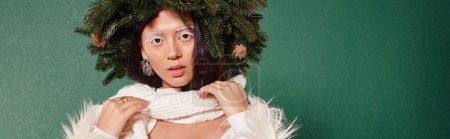 Photo for Winter beauty, woman with white makeup and natural wreath adjusting scarf under falling snow, banner - Royalty Free Image