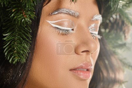 winter beauty, close up of asian woman with white eye makeup and lip balm posing with closed eyes