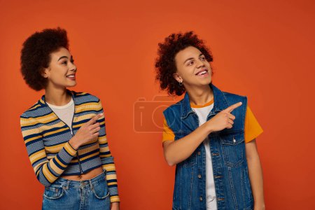 young african american brother and sister gesturing and smiling happily, family concept