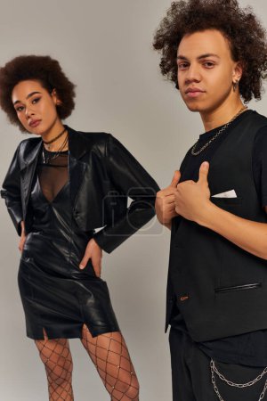 fashionable african american siblings in trendy urban clothes posing together on gray backdrop
