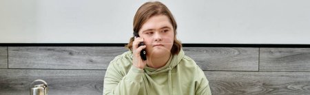 young female client with down syndrome talking on mobile phone in modern cozy cafe, banner