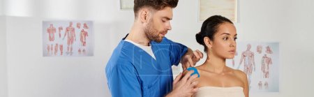 Photo for Good looking bearded doctor putting kinesiological tapes on his patient during appointment, banner - Royalty Free Image
