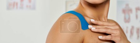 cropped view of beautiful young woman with kinesio tapes on her body during appointment, banner