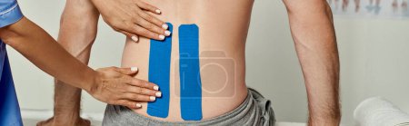 Photo for Cropped view of young female doctor putting kinesio tapes on back of her male patient, banner - Royalty Free Image