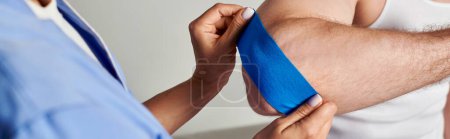 cropped view of young doctor putting kinesiological tape on elbow of her patient, healthcare, banner