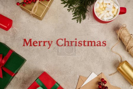 Merry Christmas greeting in frame with colorful present boxes and hot chocolate with marshmallow