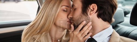 stylish and successful business couple kissing with closed eyes in luxury car, love affair, banner