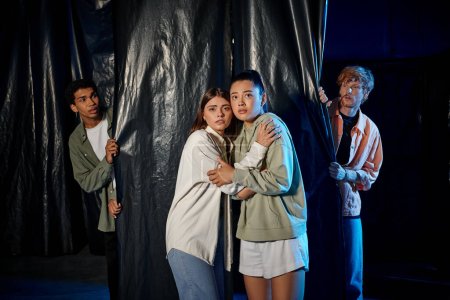Foto de Jóvenes multiculturales asustados comprometidos en emocionante desafío sala de escape, aventura interior - Imagen libre de derechos