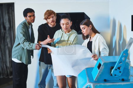 group of young interracial friends looking at blueprint and planning escape in quest room, puzzle