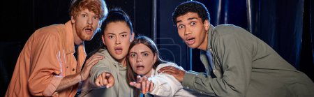 banner of diverse astonished friends discovering a clue in escape room, women pointing with finger