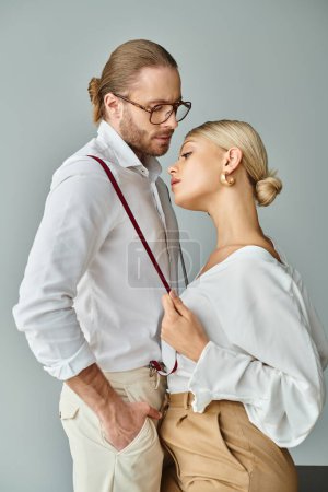 Foto de Buen aspecto sexy pareja con accesorios en trajes elegantes besándose amorosamente en la oficina, asunto de trabajo - Imagen libre de derechos