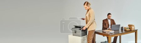 Photo for Beautiful blonde woman using copy machine while her boyfriend looking at laptop, work affair, banner - Royalty Free Image