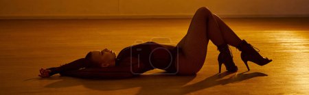 Photo for Banner of dancer finds her balance on the ground, her high heels touching the studio floor - Royalty Free Image